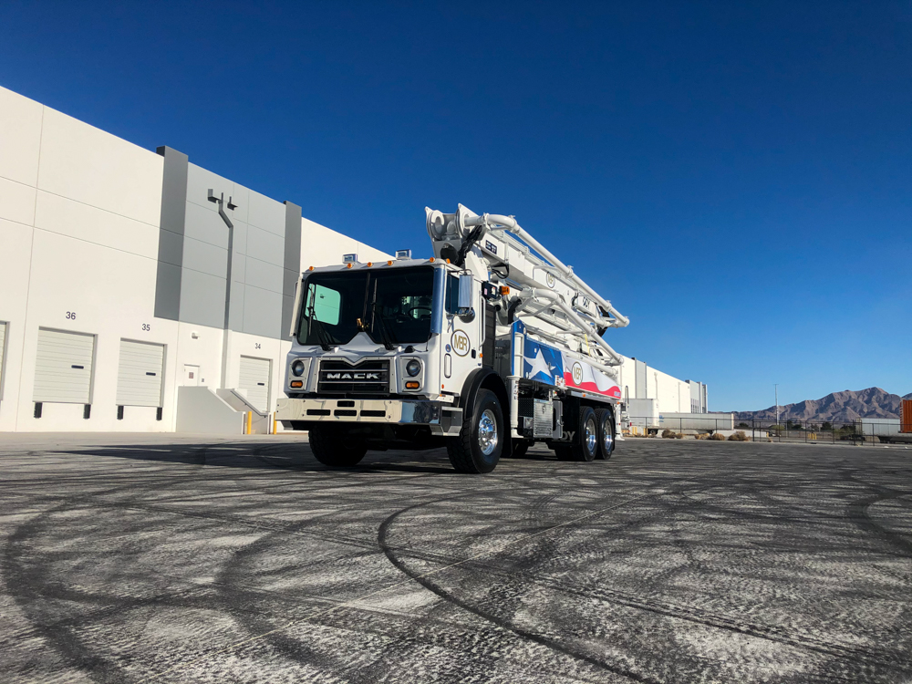 MBR concrete boom pump with Texas flag design outside of the World of Concrete event center