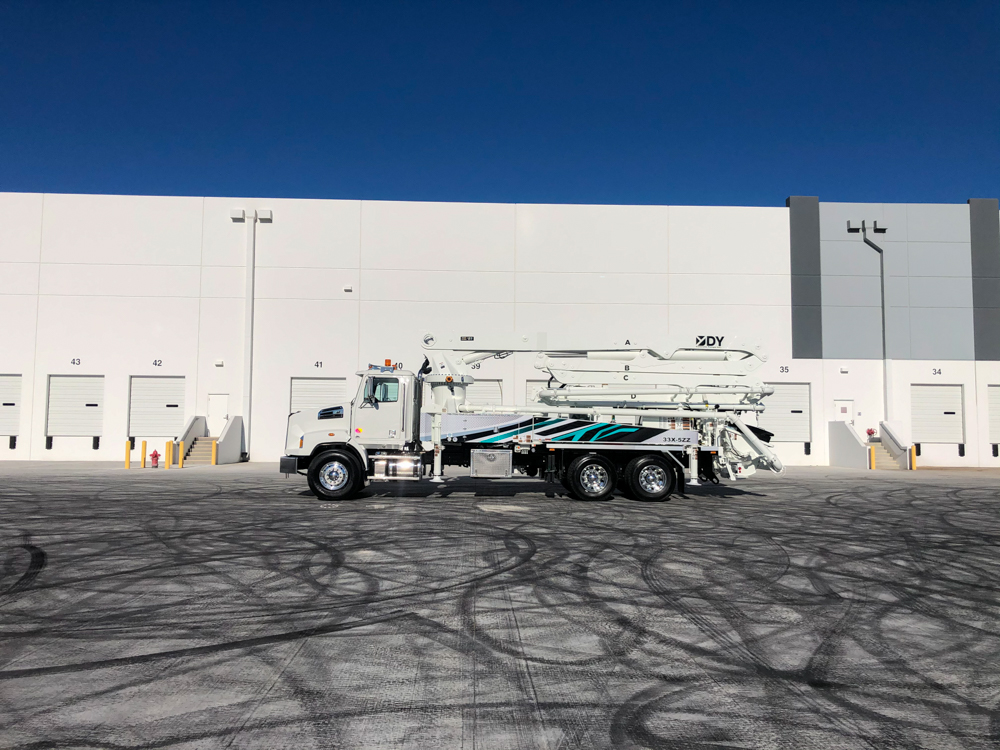 side view of a DY concrete pump on display at the WOC event