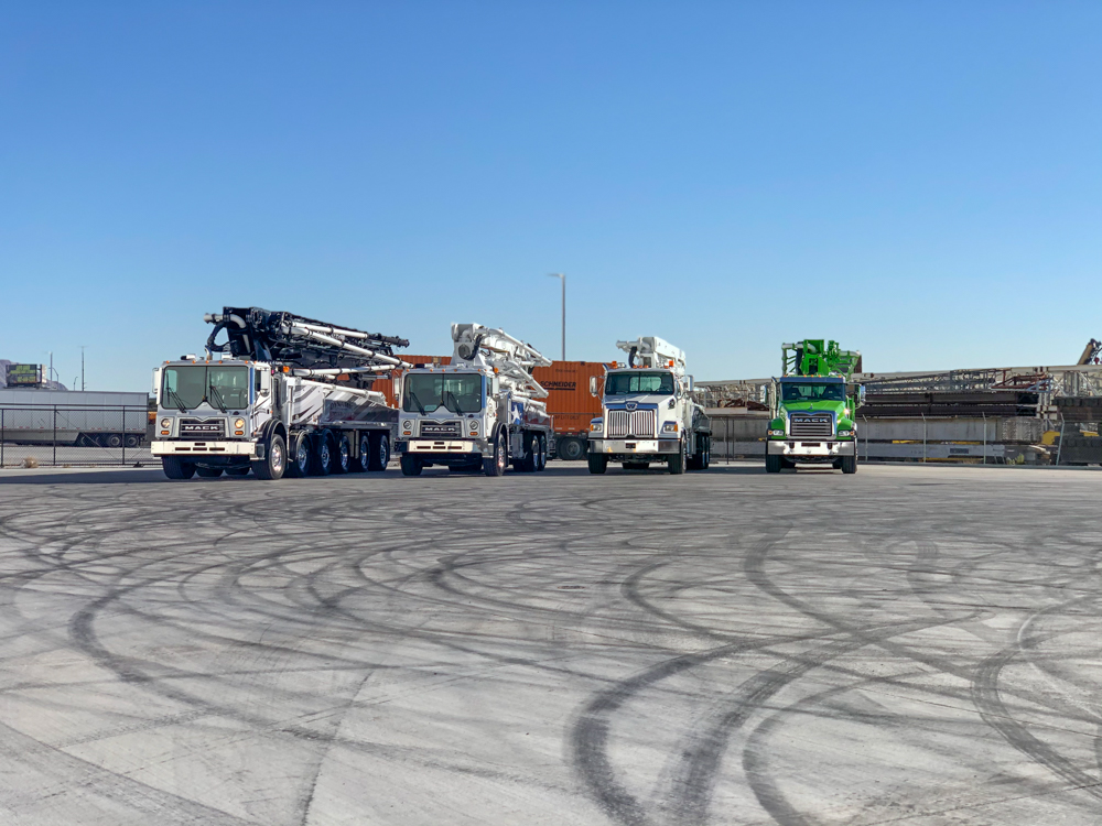 DY Concrete Pumps lined up and on display outside of the WOC event