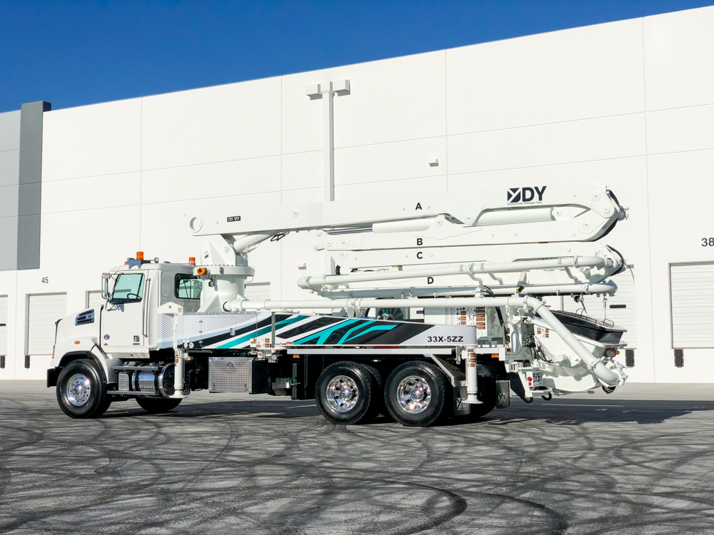DY Concrete Pumps displaying their 33X-5ZZ boom pump outside of the WOC event