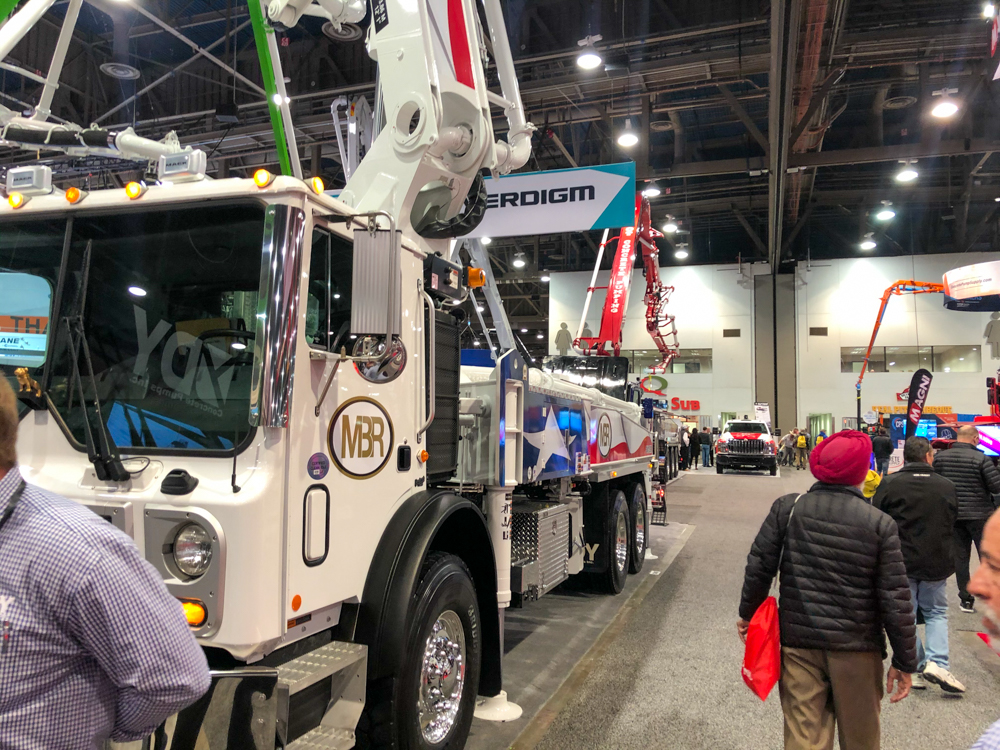 visitors at the World of Concrete event walking and looking at the pumps on display