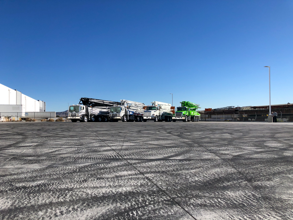 four concrete pumps manufactured by DY Concrete Pumps on display outside of the WOC event