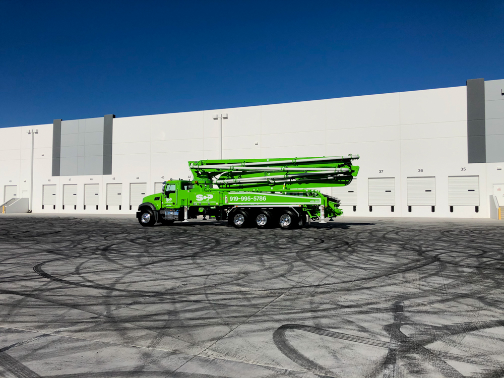 a DY Concrete Pumps manufactured boom pump on display outside of the WOC event