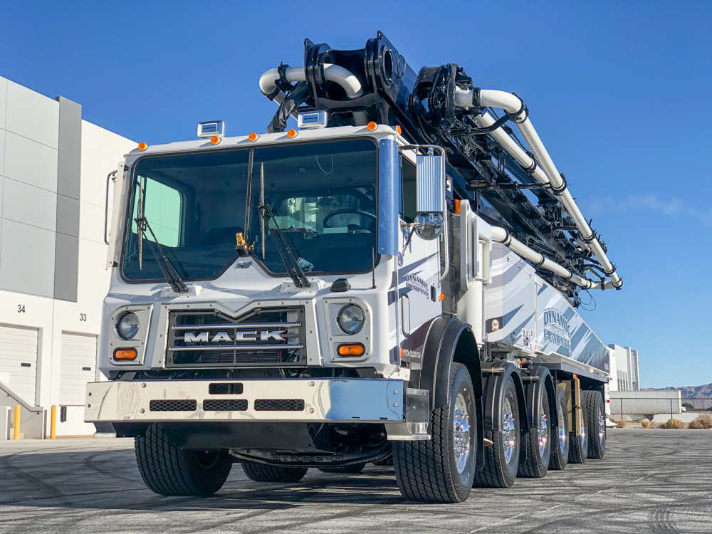 front of a Dynamic Concrete Pumping concrete pump manufactured by DY Concrete Pumps