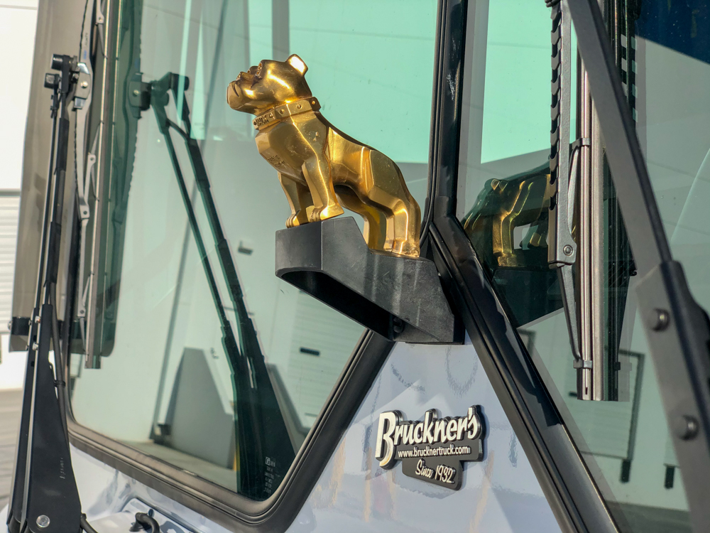 Mack Truck dog statue on front of a concrete pump